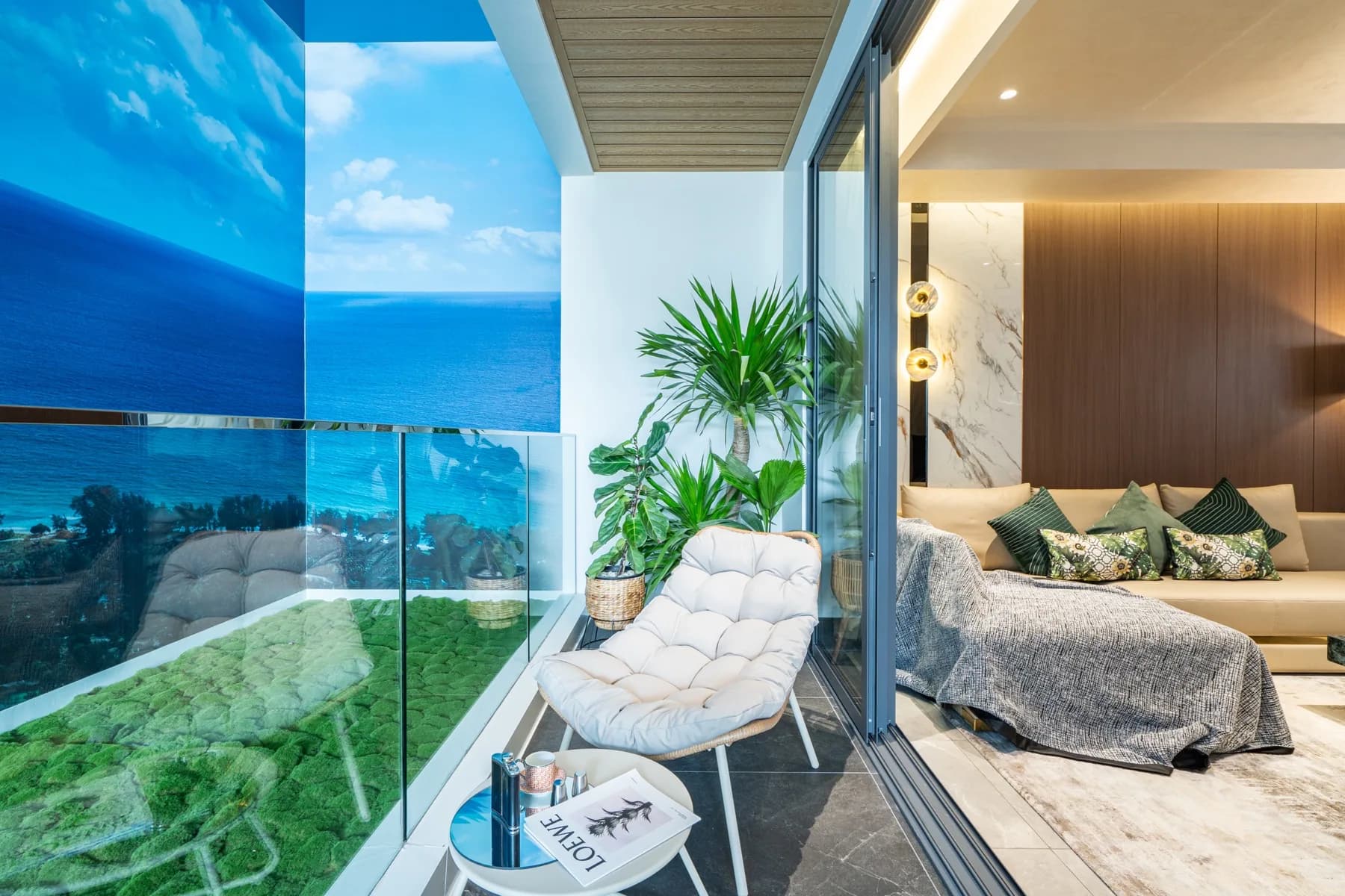 Balcony and bedroom opening in the AYANA Heights show residence with an illustrated sea-view backdrop